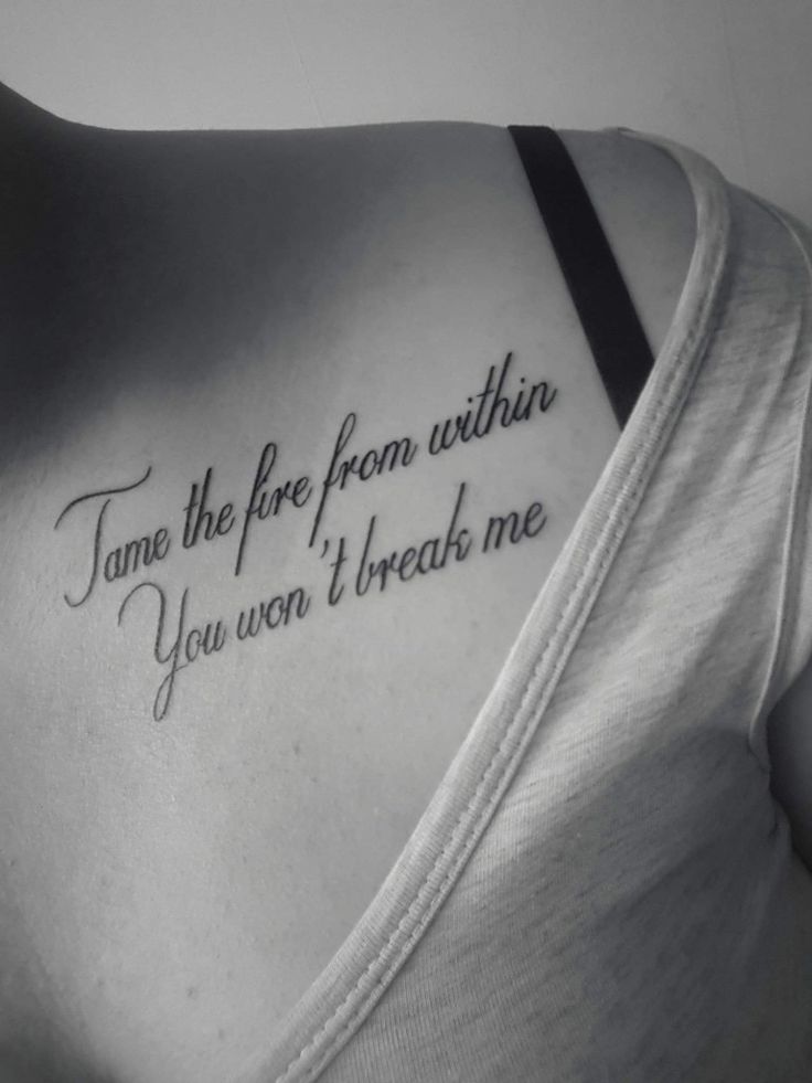 the back of a woman's shoulder with a tattoo saying, tame the fire from within you won't break me