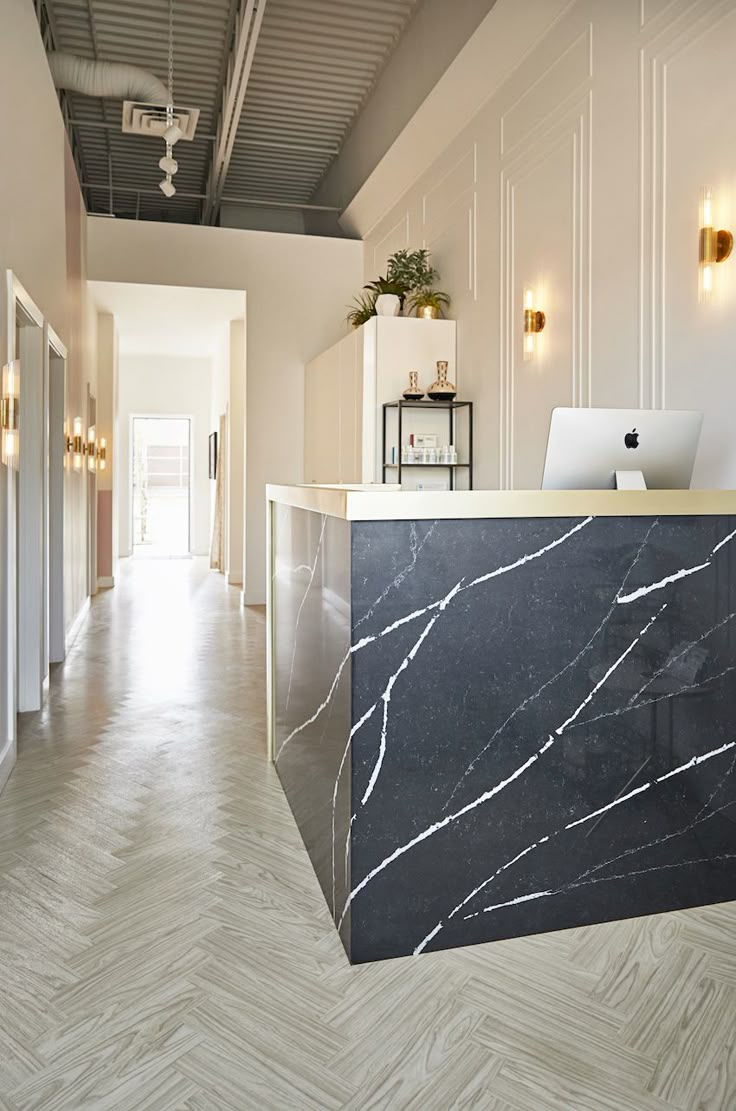 an office with marble counter top and white walls