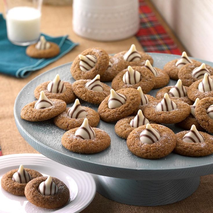 cookies with white chocolate drizzled on them are sitting on a blue plate