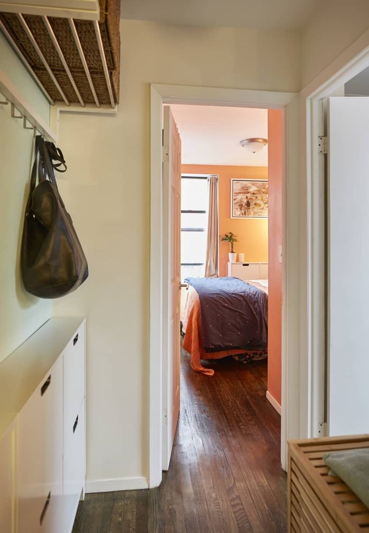 an open door leading to a bedroom with a bed and closet in the back ground