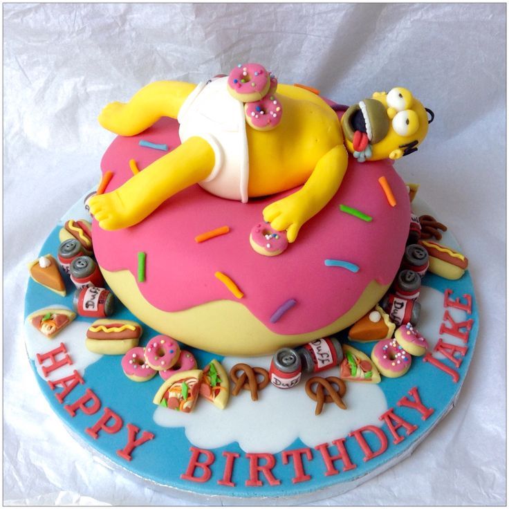 a birthday cake that is shaped like the simpsons character sleeping on top of a doughnut