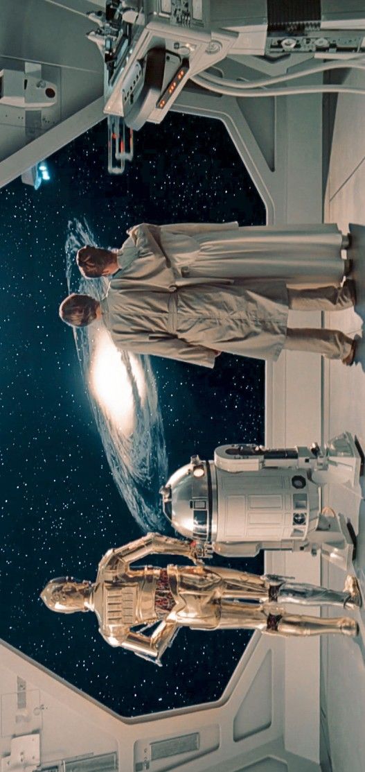 two men in space suits standing next to each other and looking up at the sky