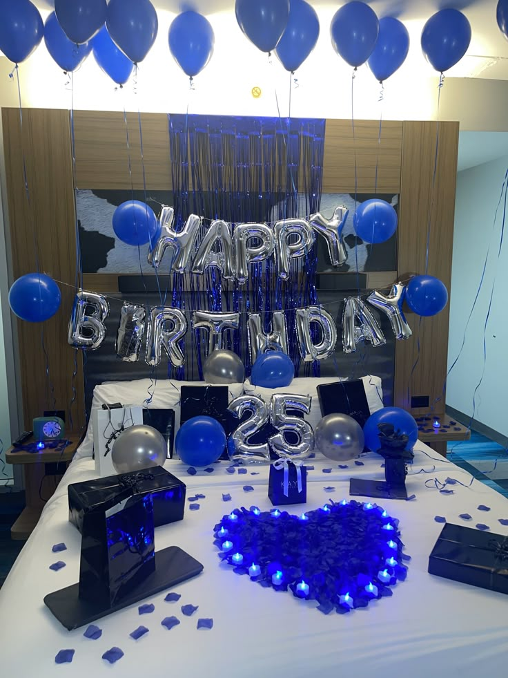 a birthday party with balloons and presents on the table