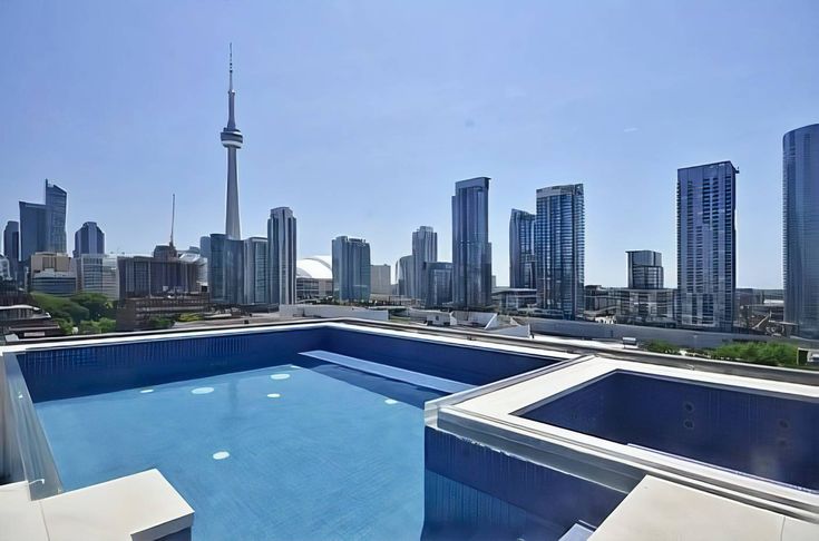 an empty swimming pool in the middle of a city with tall buildings and skyscrapers