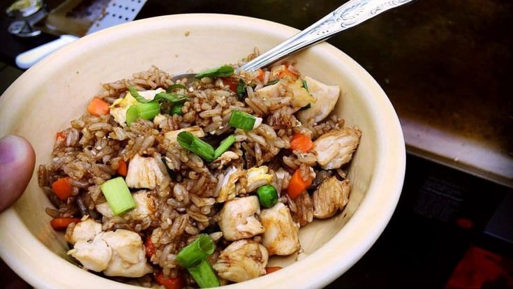 a bowl filled with rice, chicken and veggies