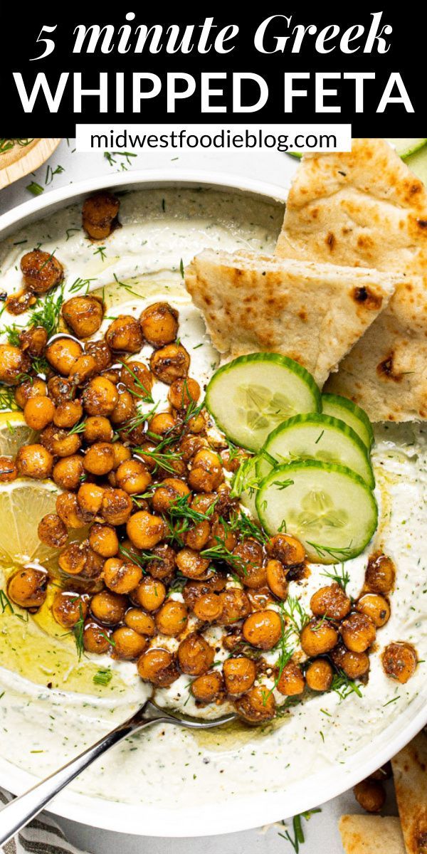 a white plate topped with chickpeas and cucumber slices next to pita bread