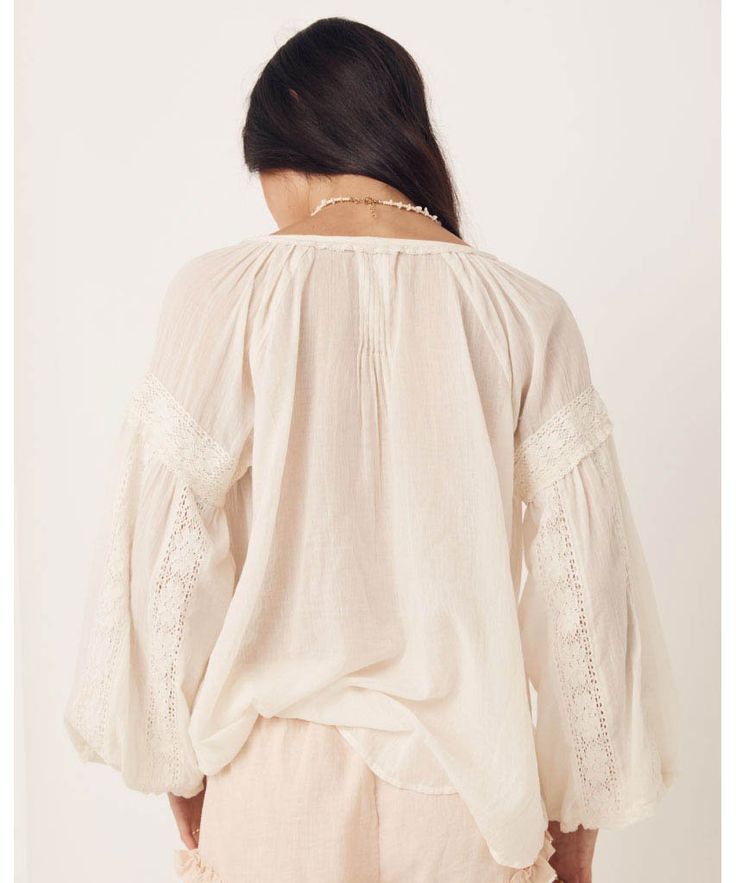 Elegant and sweet, our Magnolia Blouse features intricate details of micro ruffles, lace trims and tassels all crafted on the softest organic cotton. Pair this back with your favourite denim or dress it up with a statement skirt and jewels to take this baby from day to night. Crafted from our preferred fibre 100% organic cotton Shell buttons down front allowing it to be worn as a blouse or open as a shirt Unlined for easy wear 100% Organic Cotton Elasticated Sleeve Cuff Neck Ties Raglan Sleeve P Statement Skirt, Lace Trims, High Waist Bottoms, Feminine Dress, Antique White, Easy Wear, Lace Detail, Off Shoulder Blouse, Bohemian Style