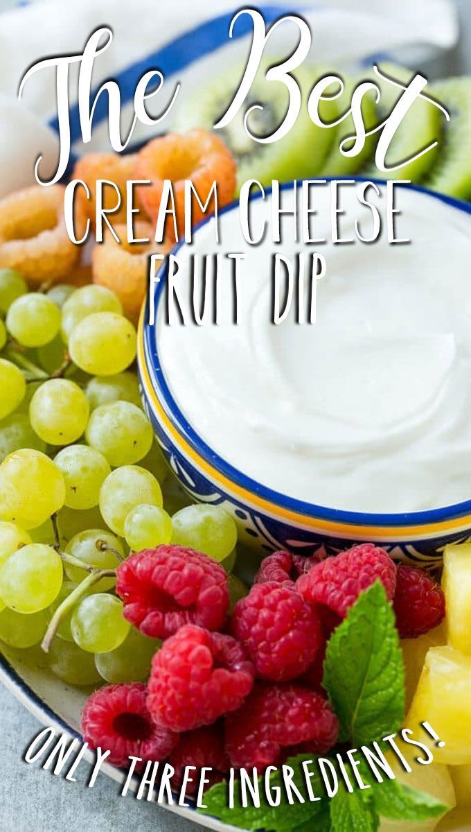 the best cream cheese fruit dip is on a plate with berries and kiwis