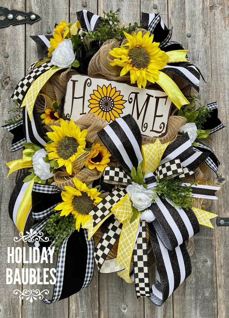 a sunflower wreath with the word home on it and some black and white ribbons