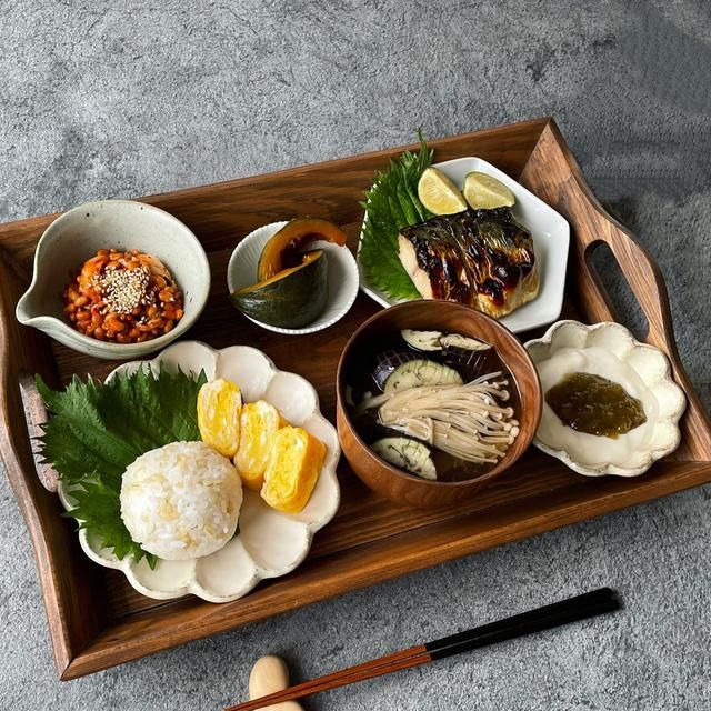 a wooden tray topped with different types of food