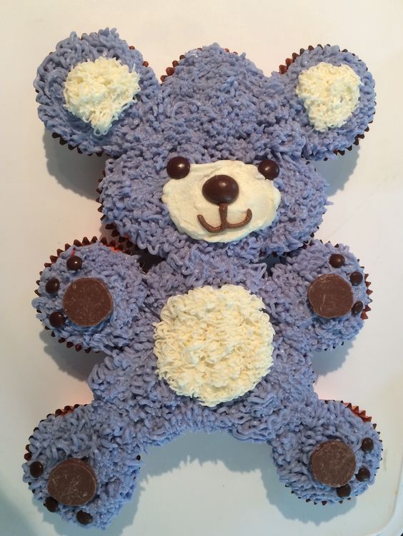 a cake shaped like a teddy bear sitting on top of a table