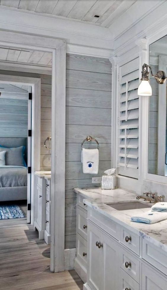 a white bathroom with two sinks and mirrors