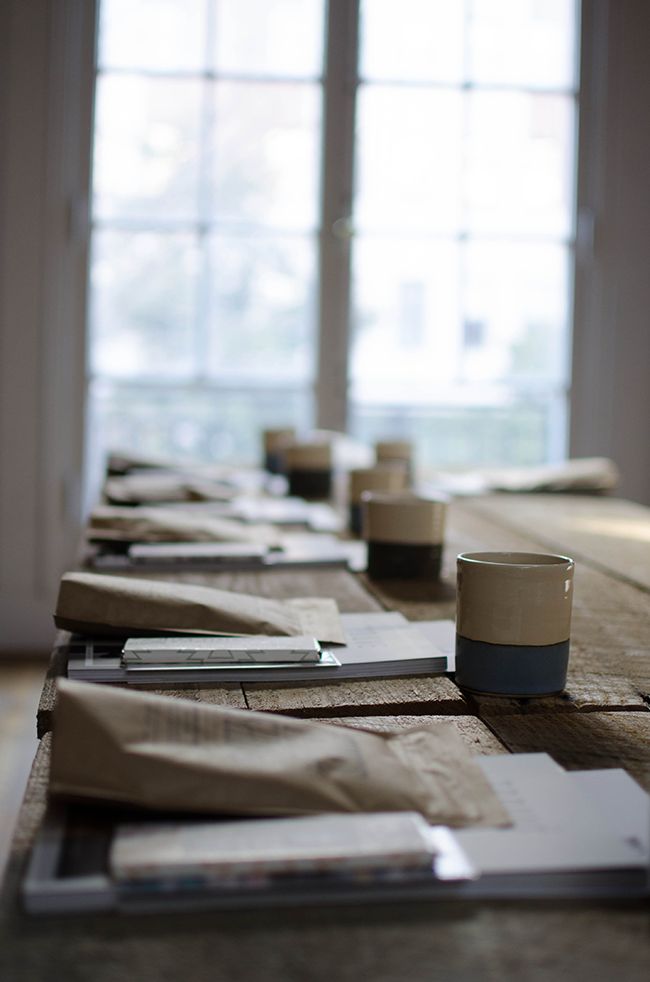 a long table with cups and papers on it