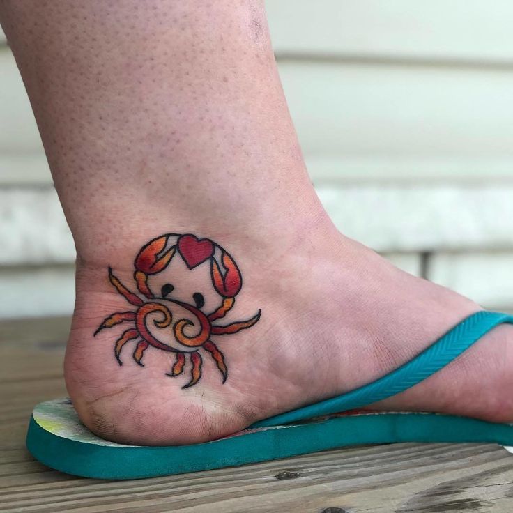 a small crab tattoo on the foot