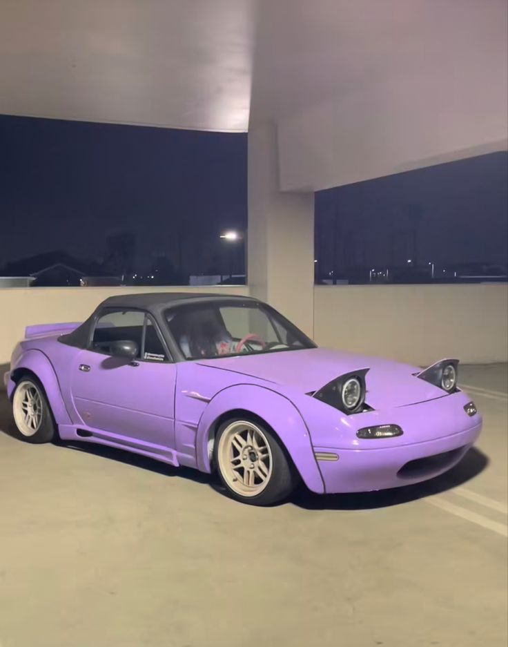 a purple sports car parked in a parking lot