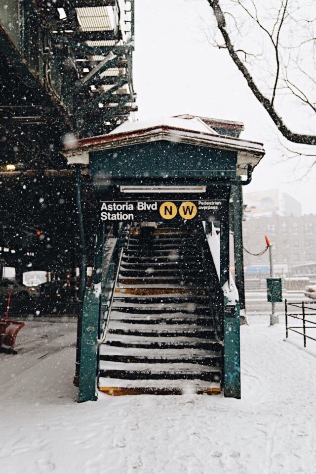 a train station covered in snow with stairs