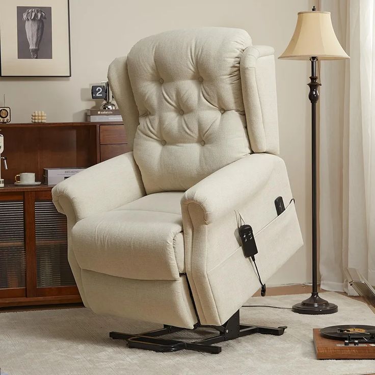 a living room with a white recliner chair and a lamp on the side table