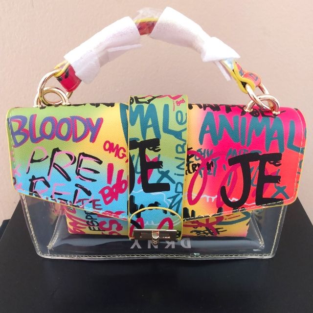 a handbag that has been painted with words on it and is sitting on a table