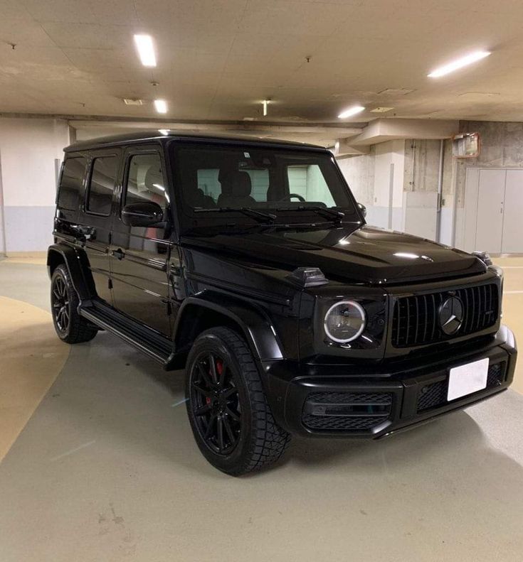 a black jeep parked in a parking garage