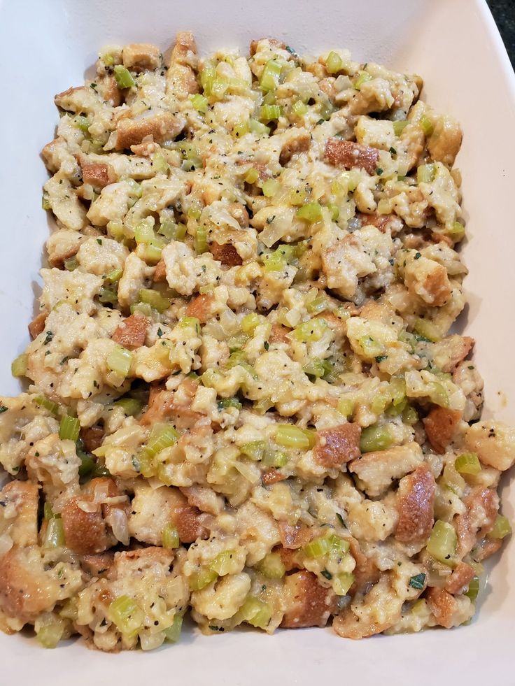 a white bowl filled with food on top of a table