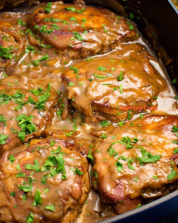 meat covered in gravy and garnished with parsley