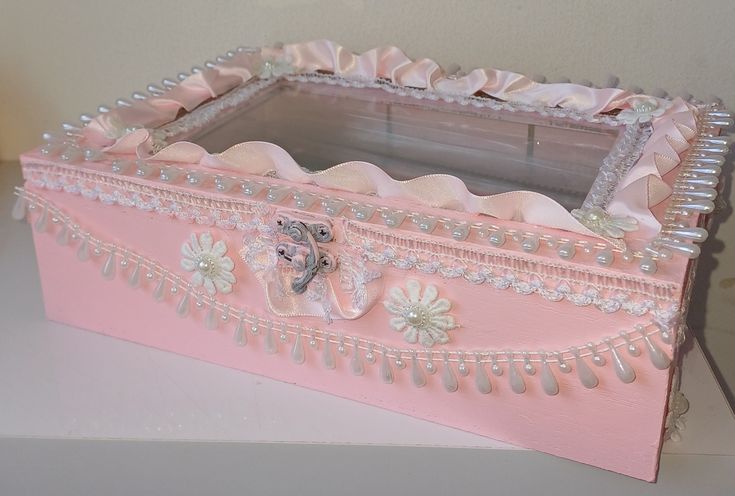 a pink box with pearls and bows on it