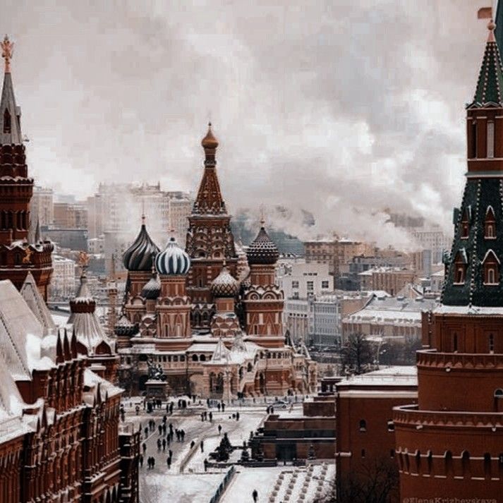 an aerial view of some buildings in the city with snow on them and people walking around