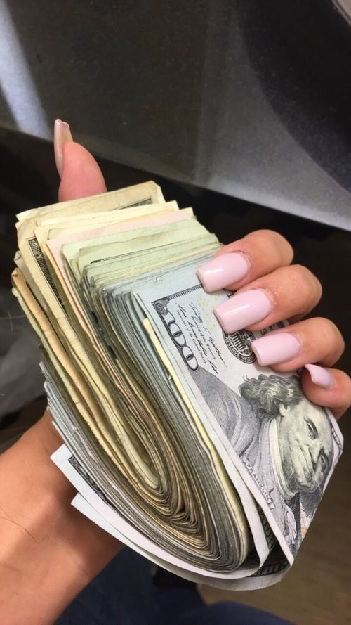 a woman is holding money in her hand