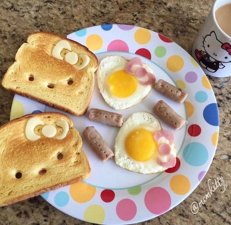 toast, eggs and sausages are arranged on a plate