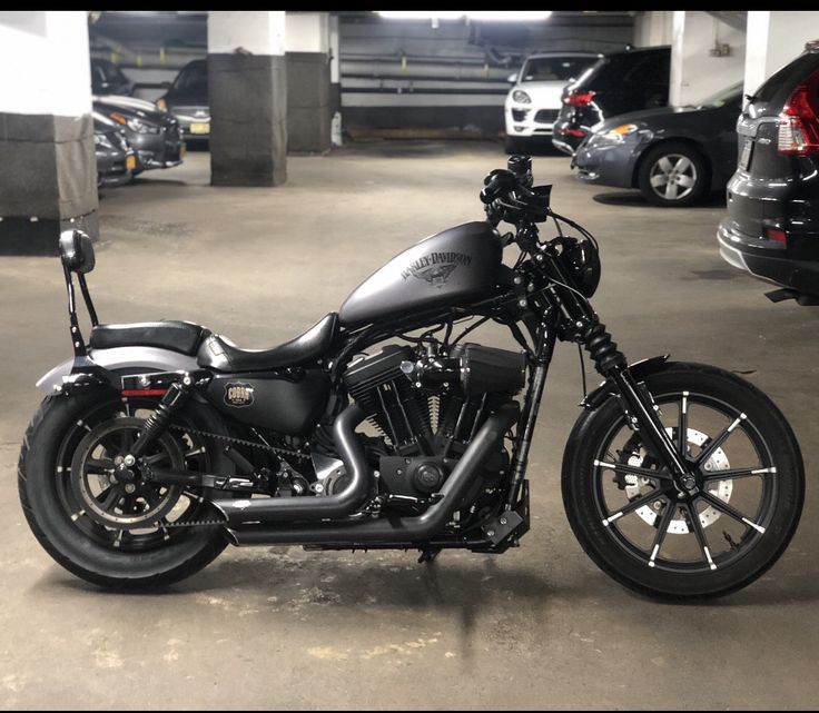 a black motorcycle parked in a parking garage