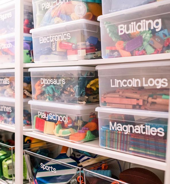 the shelves are filled with plastic bins and toys