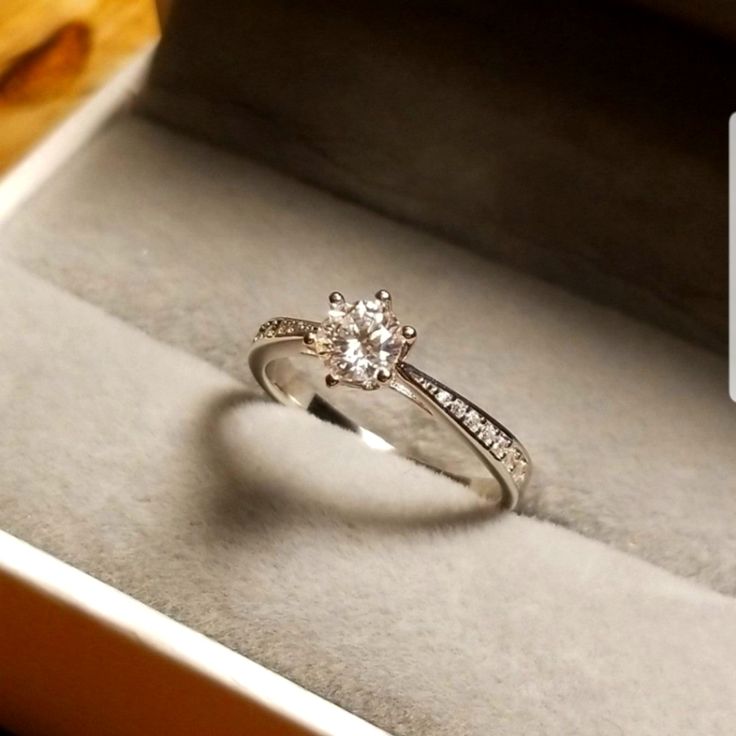 a diamond engagement ring in a box