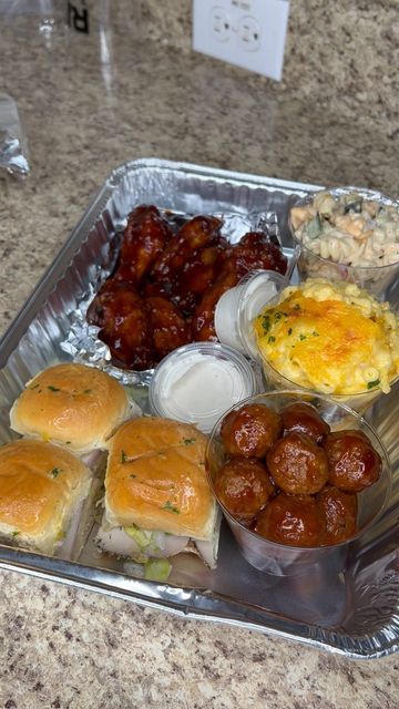 a silver tray topped with lots of food