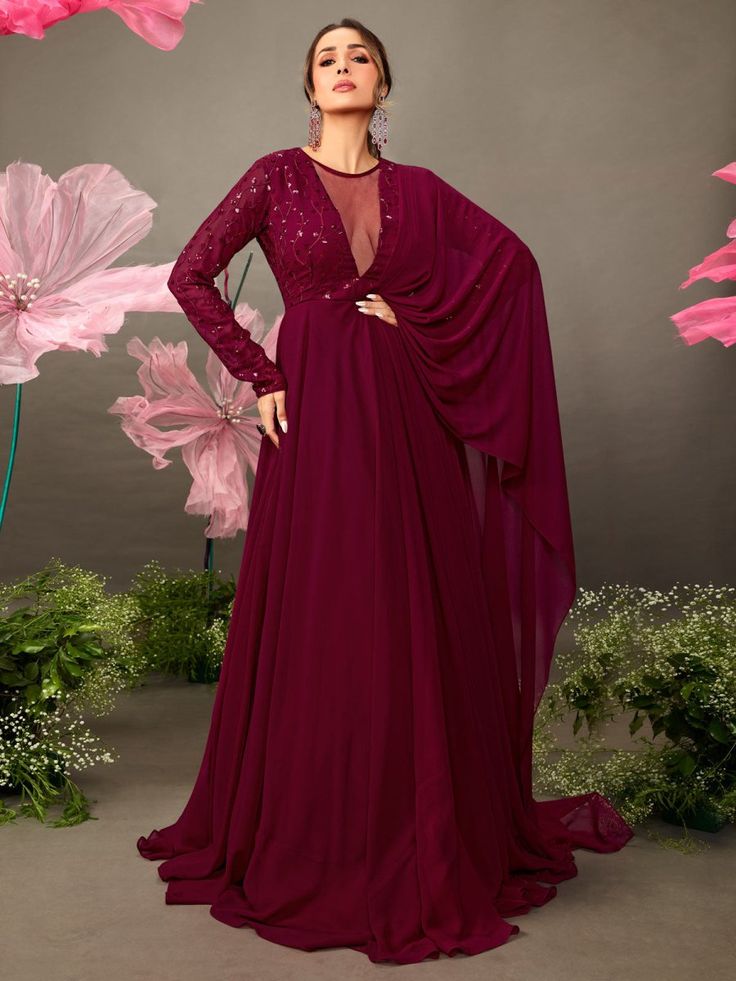 Maroon Floral Embroidered Gown with Draped Dupatta - Inddus.com Embellished V-neck Kurta For Party, Festive V-neck Gown For Eid, Festive Bollywood V-neck Maxi Dress, Bollywood Sequin V-neck Dress, V-neck Georgette Dress For Navratri, Festive V-neck Evening Gown, Semi-stitched Evening Dress With Sheer Dupatta, V-neck Embellished Kurta For Wedding, Semi-stitched V-neck Dress For Festive Occasions