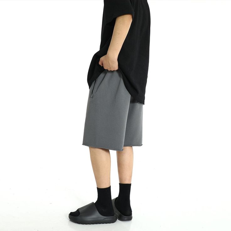 Model is 5ft 9''(176cm) tall, 145 lbs(66kg) weight and wearing a size L168cm 59kg wearing a size M - CEMENT GRAY- Drawstring- Distressed bottom Casual Relaxed Fit Mid-thigh Bottoms, Solid Color Bermuda Shorts With Relaxed Fit, Gray Relaxed Fit Athletic Shorts, Gray Short Length Bottoms For Streetwear, Casual Mid-thigh Summer Pants, Casual Mid-thigh Length Summer Pants, Solid Relaxed Fit Shorts, Gray Relaxed Fit Shorts With Short Legs, Gray Casual Short Bottoms