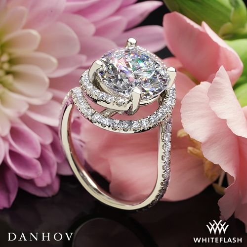 a close up of a diamond ring with flowers in the background and text overlay that reads, danhov