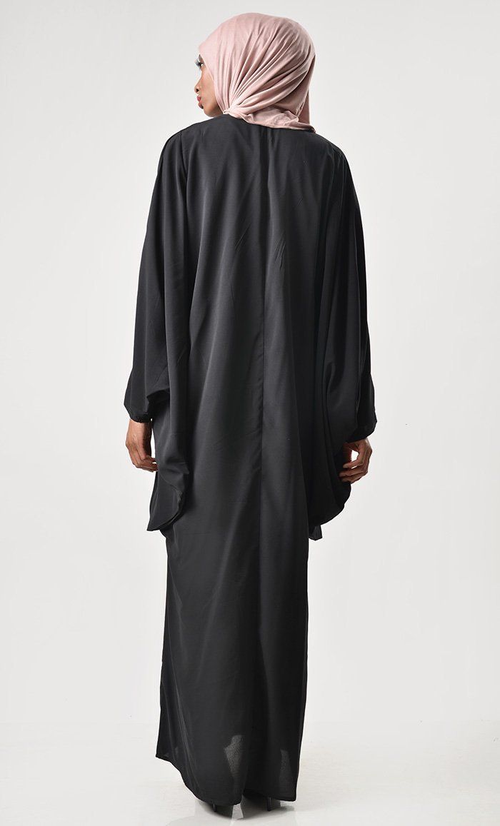 A perfect wardrobe piece for festive season Round neck Embroidered motif on shoulder with tassle Batwing Sleeves FABRIC: Nida CARE: Machine wash cold Oversized Black Abaya, Oversized Long Sleeve Black Abaya, Oversized Black Long Sleeve Abaya, Black Long Sleeve Agbada For Eid, Long Sleeve Black Agbada For Eid, Elegant Black Agbada For Eid, Black Oversized Long Abaya, Oversized Black Long Abaya, Elegant Black Tunic Thobe