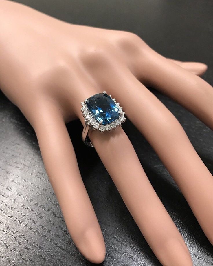 9.75 Carats Natural Impressive LONDON BLUE TOPAZ and Diamond 14K Yellow Gold Ring Suggested Replacement Value Approx. $6,000.00 Total Natural London Blue Topaz Weight: Approx. 9.00 Carats (Heated, Irradiated) London Blue Topaz Measures: Approx. 16 x 12mm Natural Round Diamonds Weight: Approx. 0.75 Carats (color G-H / Clarity SI1-2) Ring total weight: Approx. 7.5 grams Disclaimer: all weights, measurements and colors are approximate and may vary slightly from the listed dimensions or as seen in t Luxury Blue Topaz Cushion Cut Ring, Elegant Blue Emerald Cut Gemstones, Elegant Emerald Cut Blue Gemstones, Luxury Baguette Cut Gemstones, Luxury Formal Blue Topaz Ring, Luxury Topaz Ring With Halo Setting, Luxury Blue Topaz Halo Ring, Blue Cushion Cut Diamond Ring For Formal Occasions, Formal Blue Cushion Cut Diamond Ring