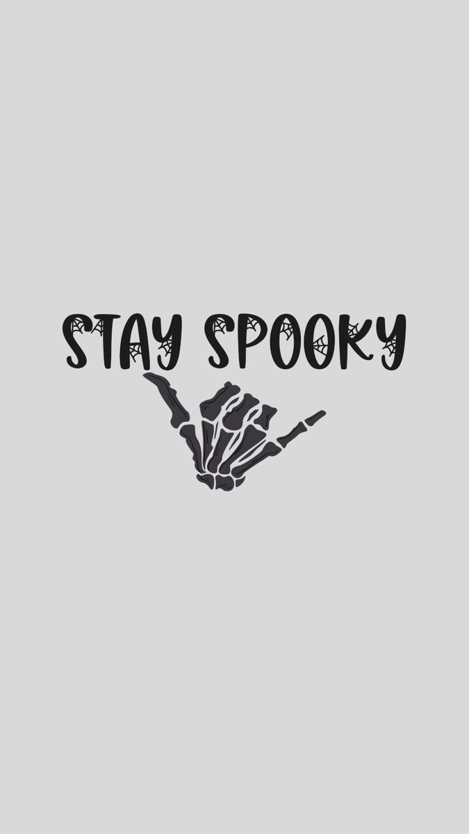 the words stay spooky written in black on a gray background with an image of a