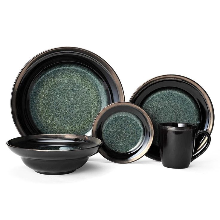 a black and green dinner set with two cups, saucers and one bowl on the side