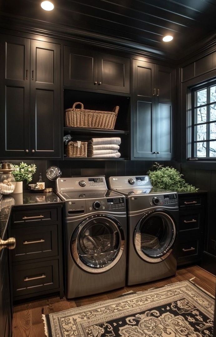 a washer and dryer in a room with black cabinets, rugs and drawers