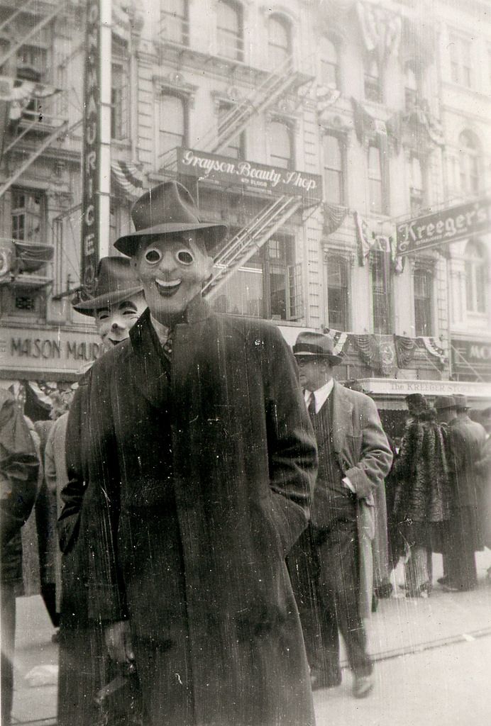 an old black and white photo of a man wearing a top hat, overcoat and trench coat