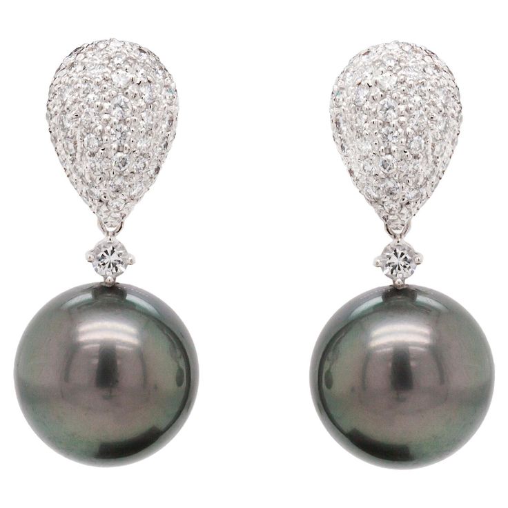 Boasting a glamorous design, these 18 carat white gold night and day dangle earrings will make a lasting impression whenever they are worn. The luxurious pieces feature a beautiful teardrop shaped dome stud exquisitely inlaid with fine quality round brilliant cut diamonds, all grain set in open back settings. To accompany the stud is a gorgeous detachable pendant set with a slightly bigger, round brilliant cut diamond, hanging beautifully below the elegant studs, adding extra brilliance and brin Gold Night, Detachable Pendant, Dark Grey Colour, White Gold Drop Earrings, Yellow Gold Drop Earrings, White Gold Diamond Earrings, Black Pearls, Night And Day, Pearl And Diamond Earrings