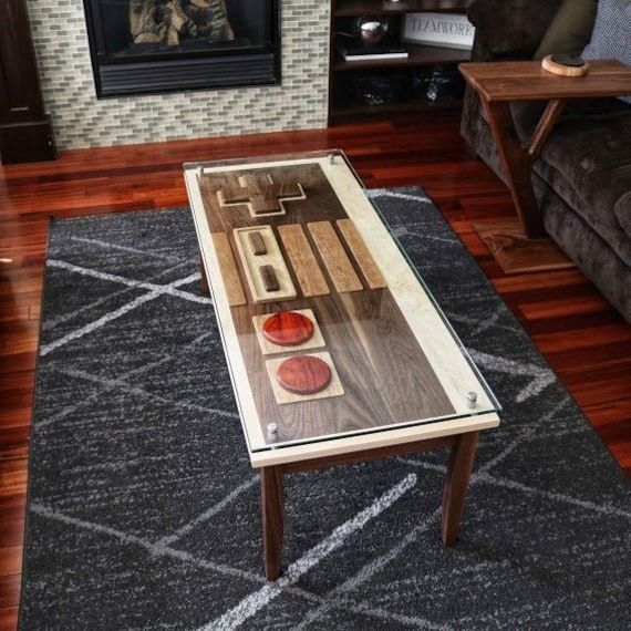 a coffee table sitting on top of a wooden floor in front of a fire place