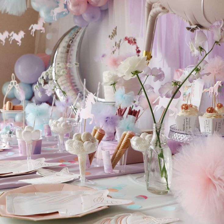 a table topped with lots of pink and blue decorations