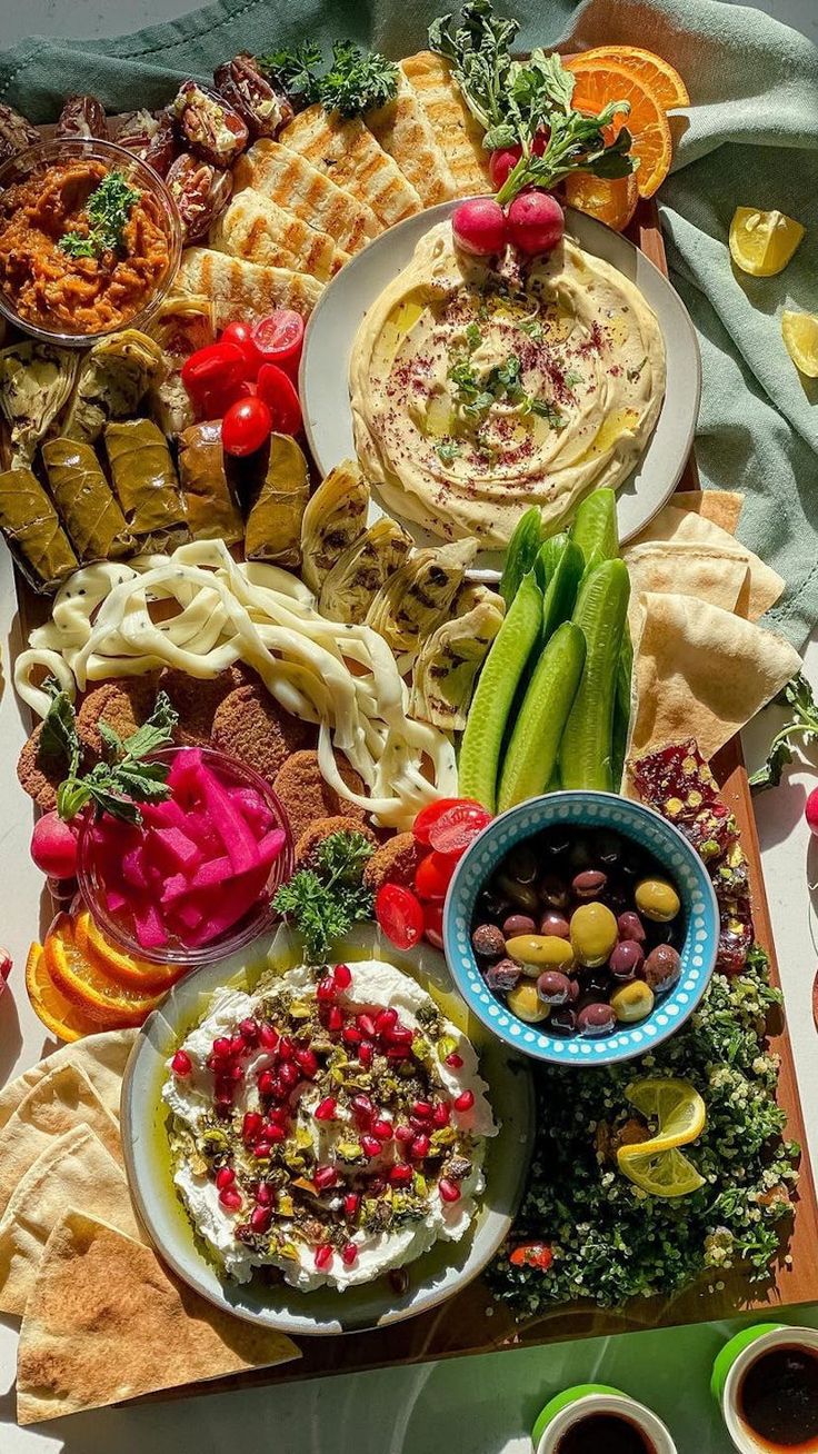 a table topped with plates and bowls filled with food