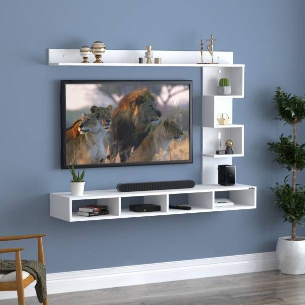 a living room with blue walls and white shelving unit containing a television on the wall