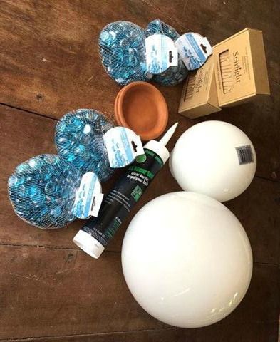 two white balls and some blue bottles on a wooden floor