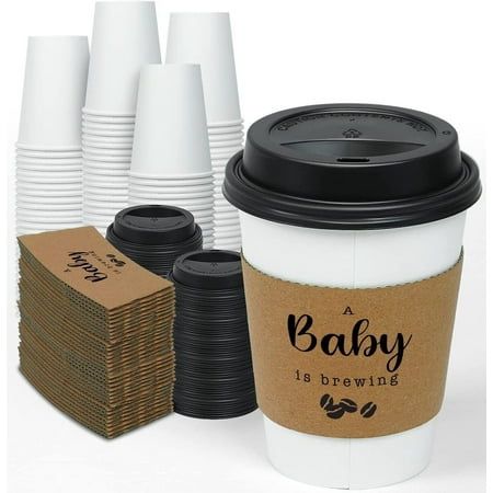 a coffee cup with its lid open next to several stacks of paper plates and napkins