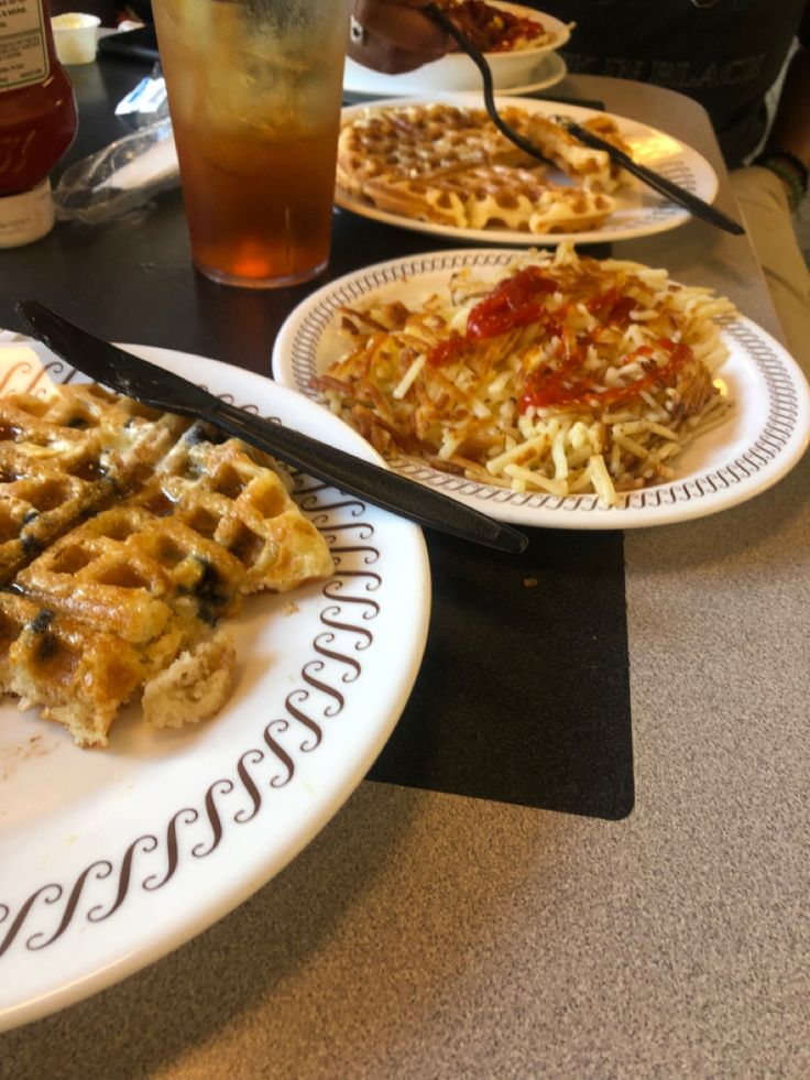 waffles and other food on plates at a restaurant